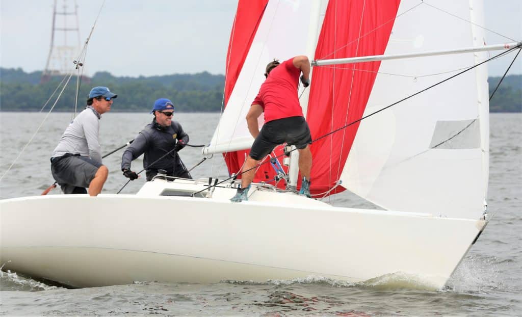 Sailboats racing on the Chesapeake Bay and Annapolis, Maryland with crews and spinnakers and fleets of sailboats.