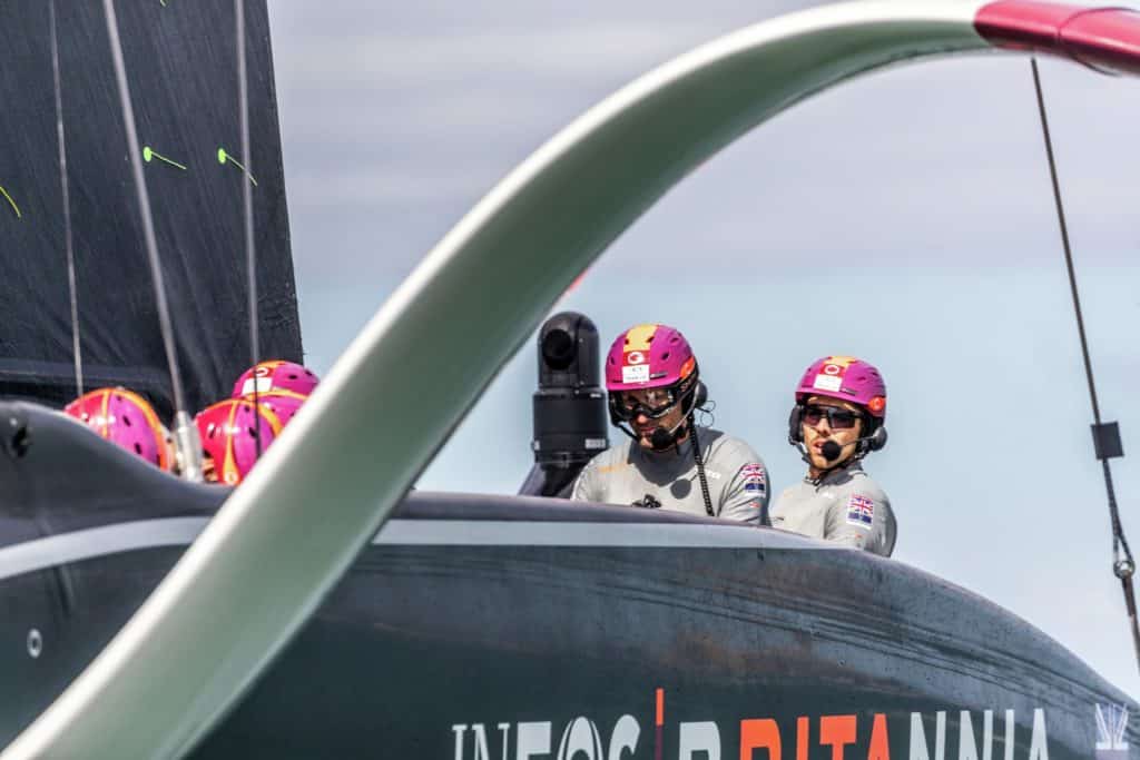 Ineos Team UK closeup showing foil arm and helmsman Ben Ainslie, behind him his mainsail trimmer Bleddyn Mon.