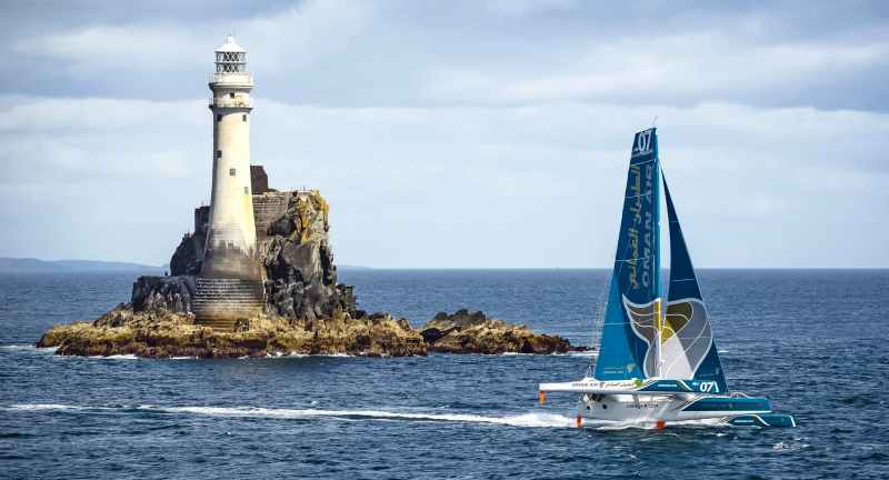 MOD 70, Oman, rounds the Fastnet Rock in the 2013 race.