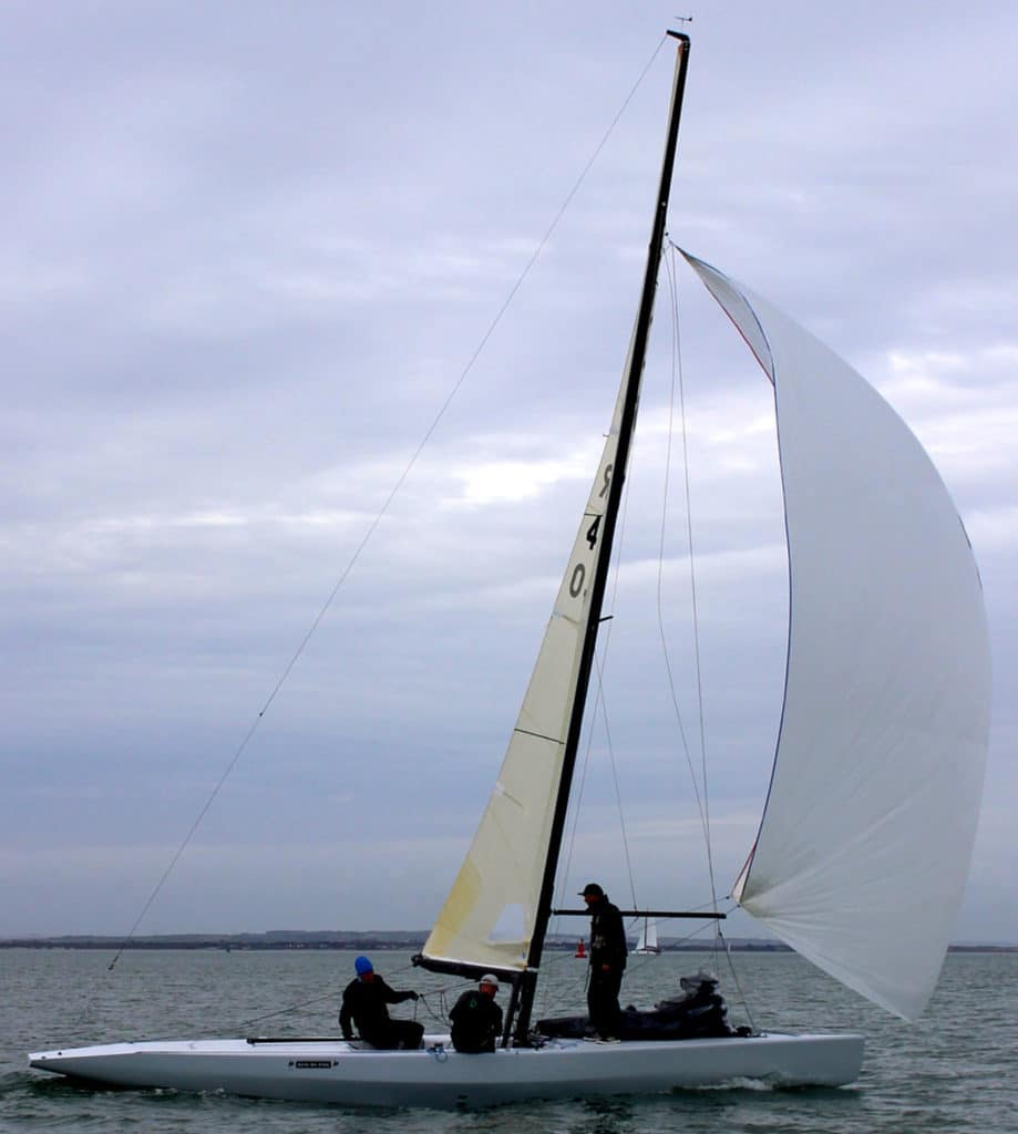 Sailboat sailing downwind with mast leaning forward over the deck