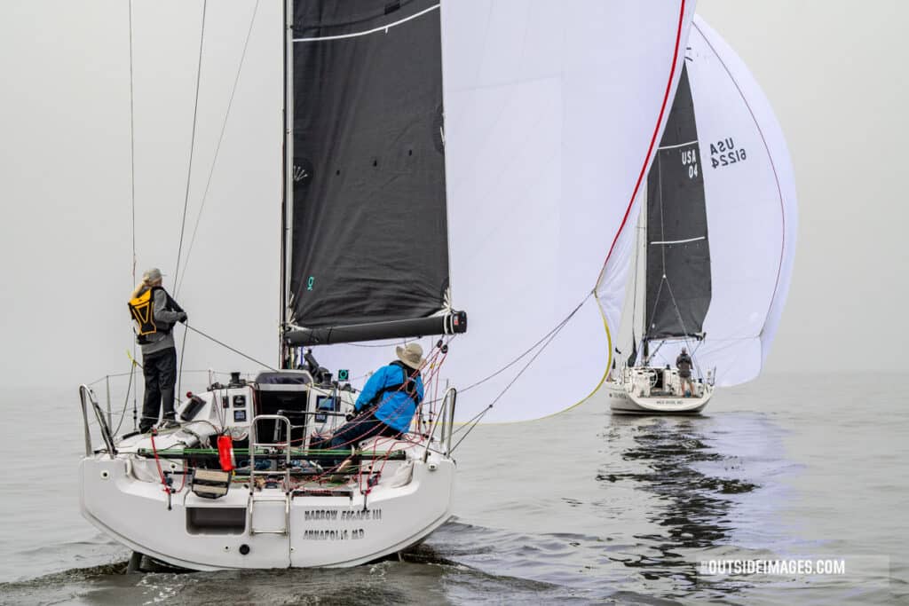 Sailboat under spinnaker racing in the fog in Annapolis, Maryland