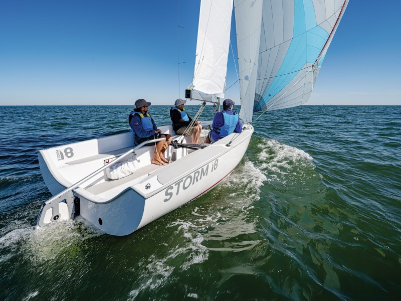 Mike Ingham, on the helm, Erik Shampain on the jib trim and Dave Reed, to port